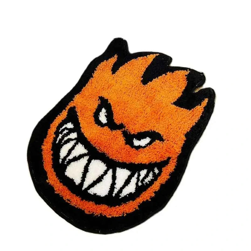 Tapete Chama Monster tufted laranja e preto sobre fundo branco