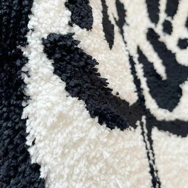 Textura felpuda em preto e branco do tapete bumbum